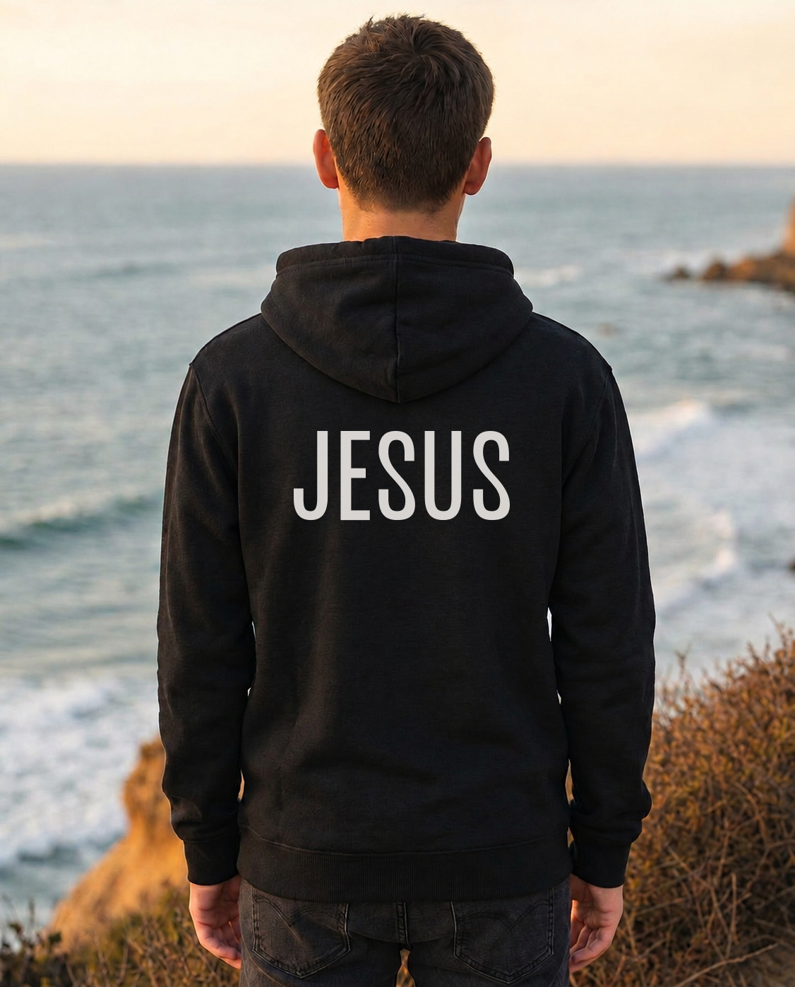 Thumbnail — Youth black “The Answer Is...” Christian hoodie back with “Jesus” print